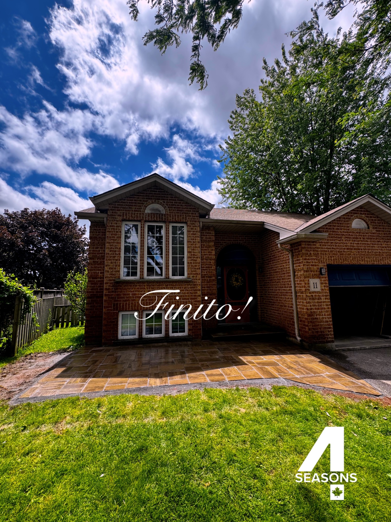Completed interlocking paver front entry and walkway at a brick home.