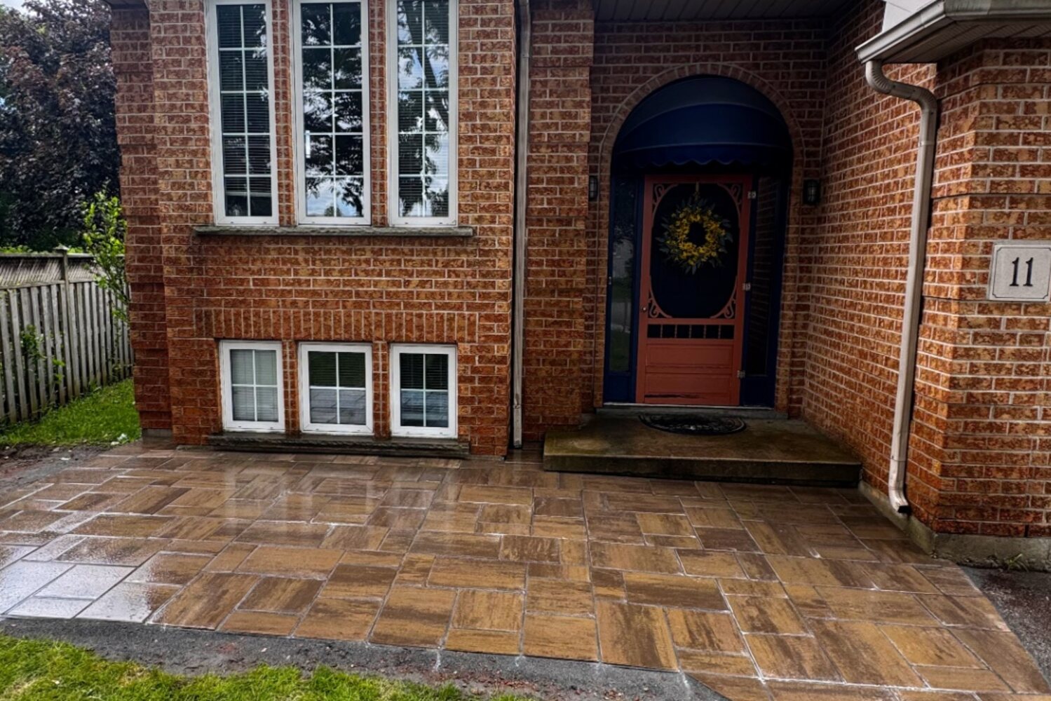 Newly laid interlocking paver patio and walkway leading to the front entrance of a brick home in Brantford.