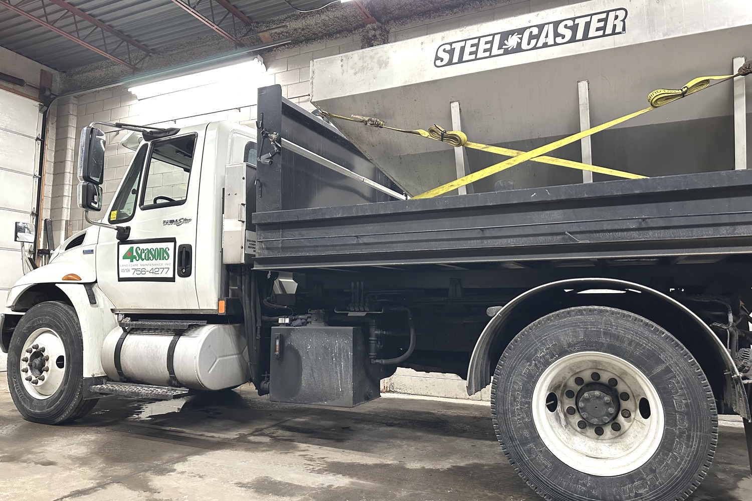Salt truck applying salt to a commercial lot in Brantford during winter.
